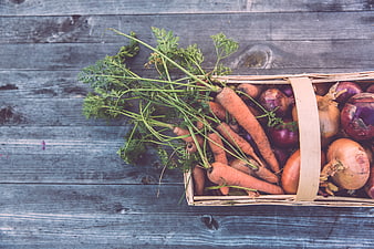 Top View of Fresh Carrots and Onions in Wooden Crate