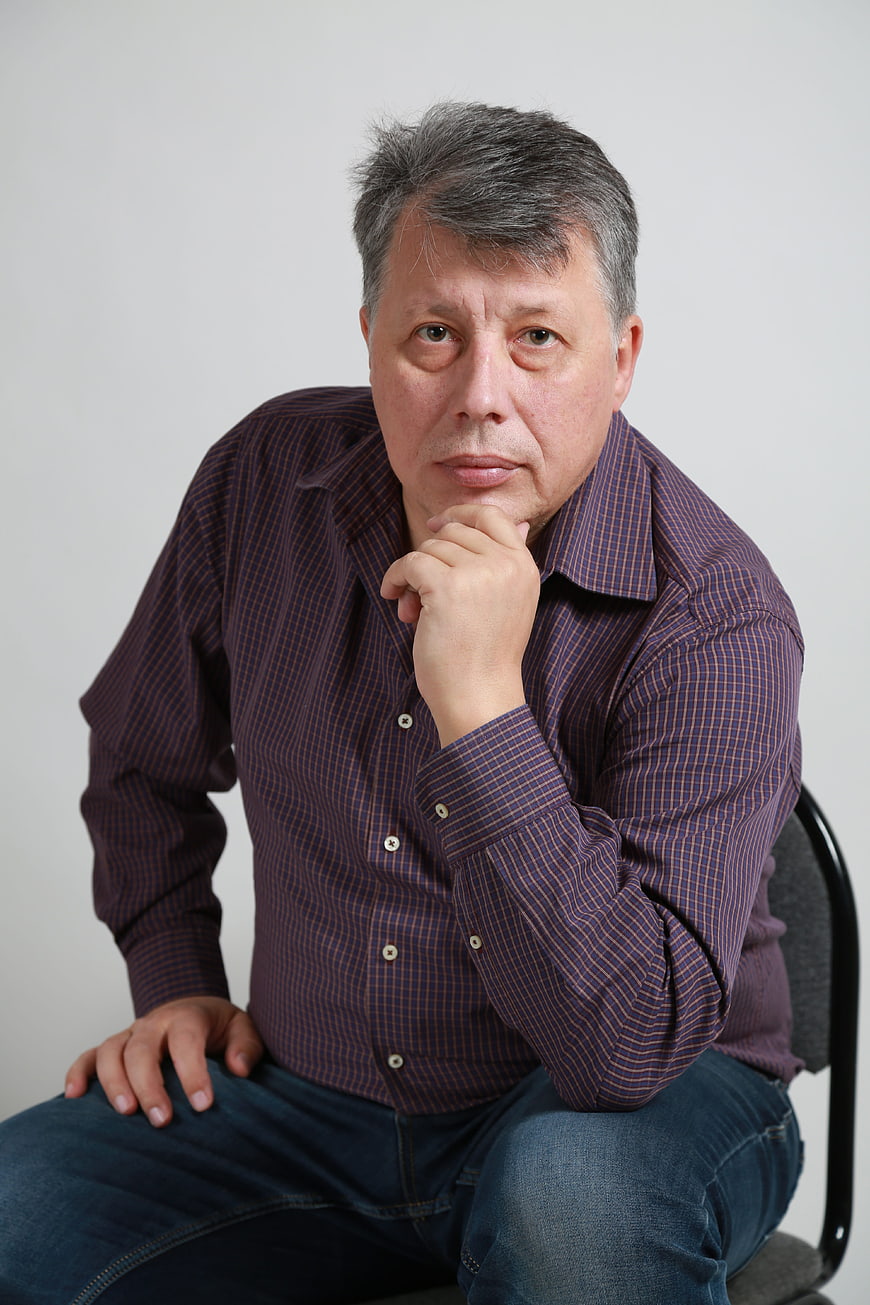 Portrait of a mature man in a purple shirt