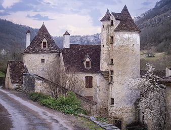Medieval stone castle with conical towers in French countryside