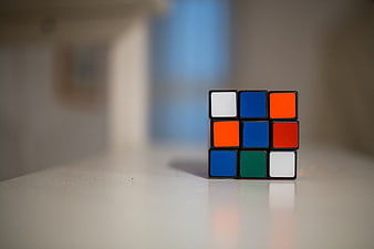 Unsolved Rubik's Cube on White Surface