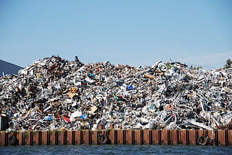 Massive pile of scrap metal waste at recycling facility