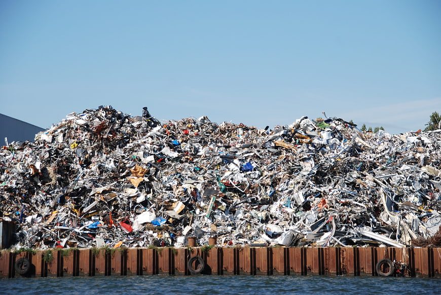 Massive pile of scrap metal waste at recycling facility
