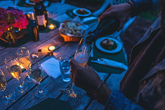 Pouring Champagne at a Romantic Outdoor Dinner