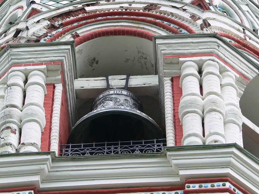 Close-up of ornate church bell tower with red brick and white columns