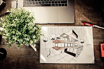 Architectural sketch of modern house on wooden desk