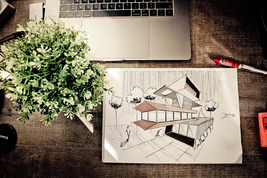 Architectural sketch of modern house on wooden desk