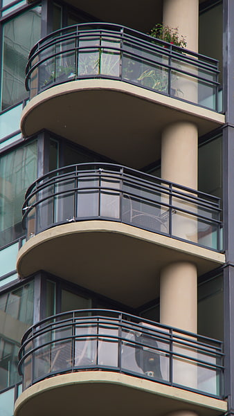 Modern Apartment Building with Curved Balconies and Glass Railings