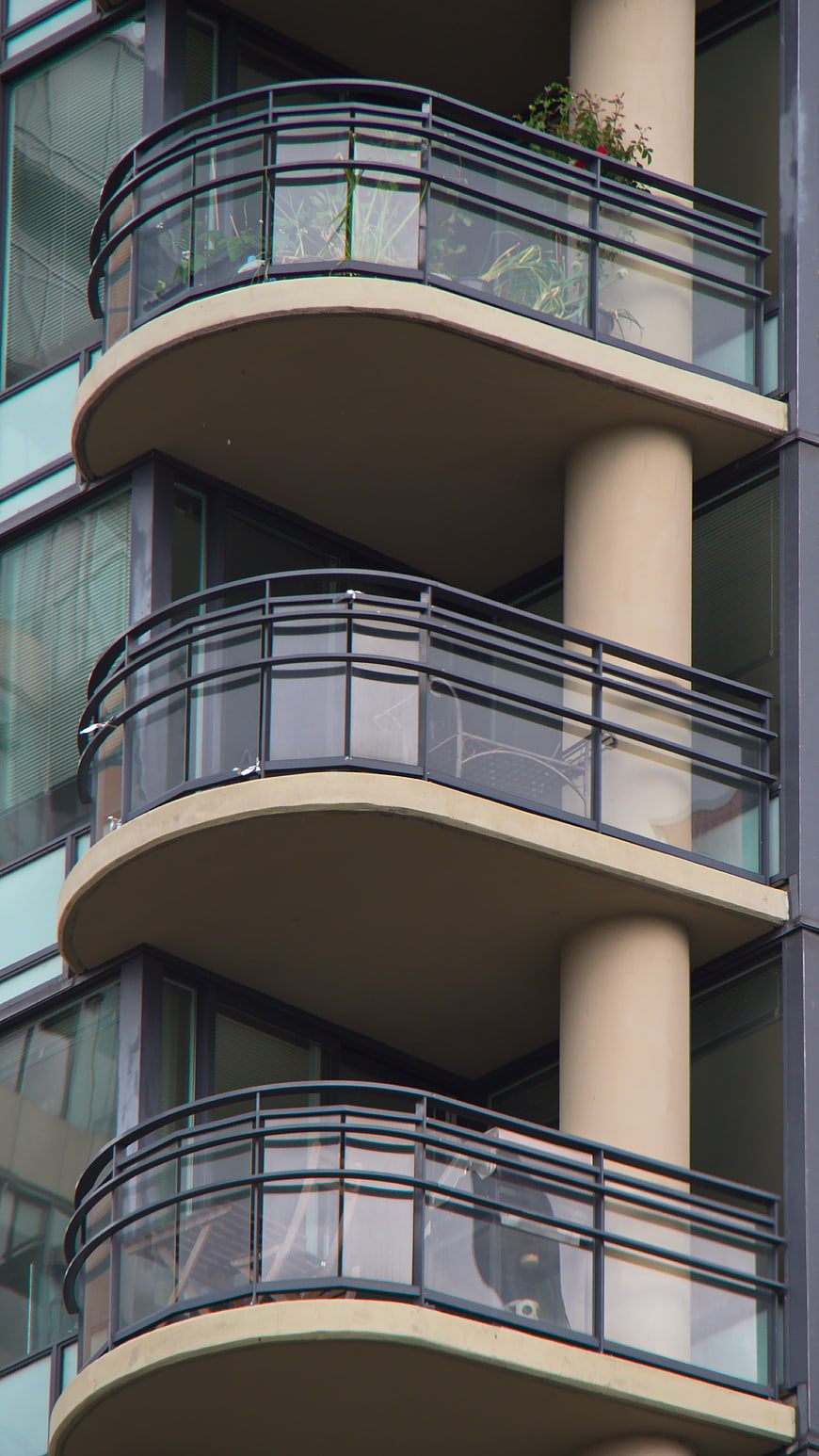 Modern Apartment Building with Curved Balconies and Glass Railings