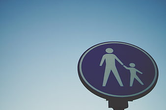 Blue Pedestrian Sign with Adult and Child Symbol Against Sky