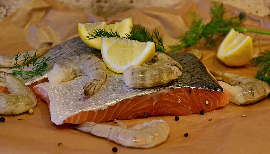 Raw Salmon Fillet with Shrimp, Lemon, and Dill on Parchment Paper