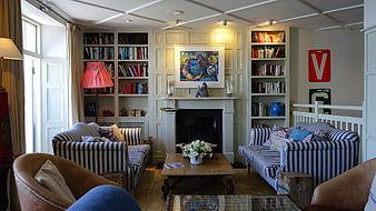 Cozy Living Room with Striped Sofas and Bookshelves