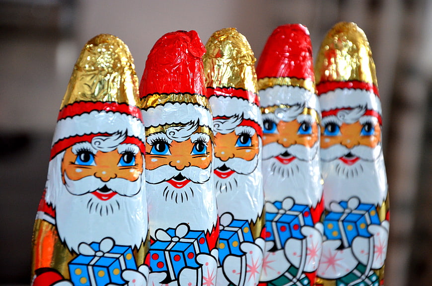 Row of Santa Claus Chocolate Easter Eggs with Gifts