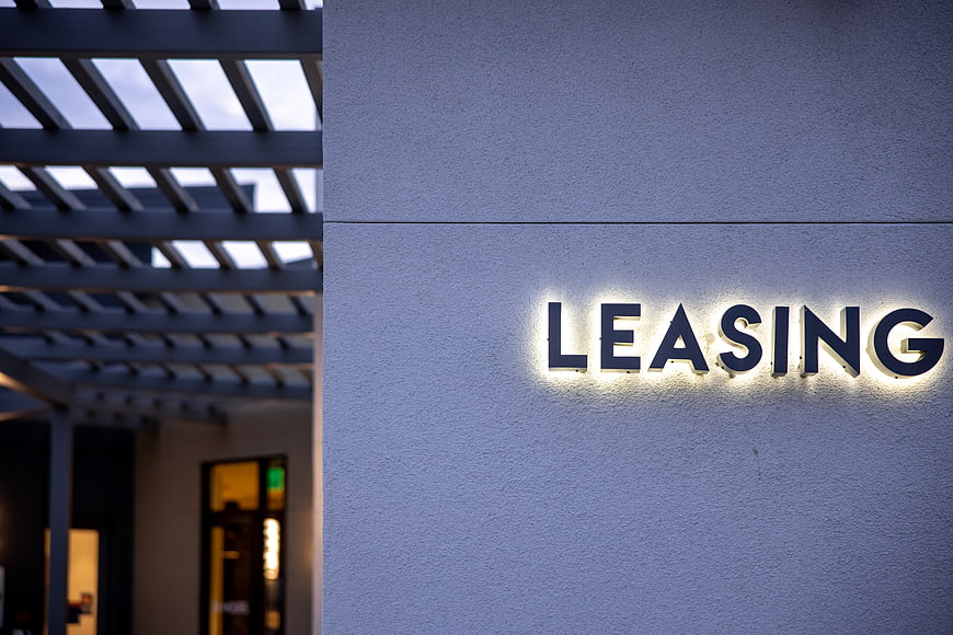 Illuminated Leasing Sign on Modern Building Exterior