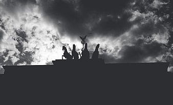 Silhouette of Quadriga Statue Against Dramatic Cloudy Sky