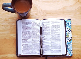 Open Bible with Pen and Coffee Cup on Wooden Table