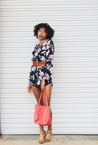 Stylish Woman in Floral Romper with Pink Tote Bag
