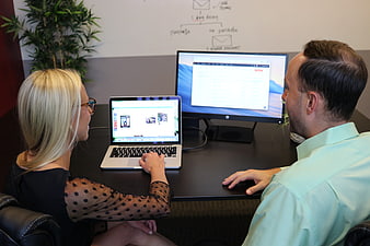 Business Team Reviewing Website Design On Laptop And Monitor