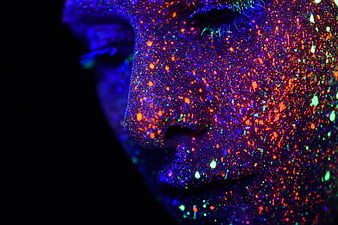 Close-up of face with glowing neon UV paint