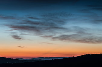 Dramatic Sunset Sky Over Silhouetted Mountain Hills