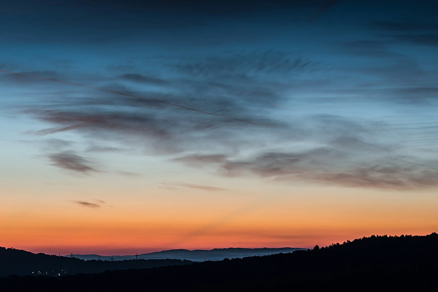 Dramatic Sunset Sky Over Silhouetted Mountain Hills
