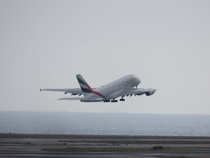 Emirates Airbus A380 taking off over ocean runway