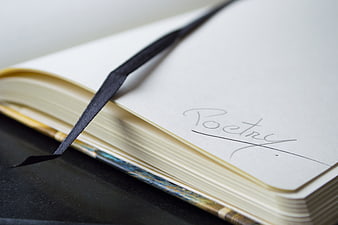 Open Notebook with Handwritten Poetry Title and Ribbon Bookmark