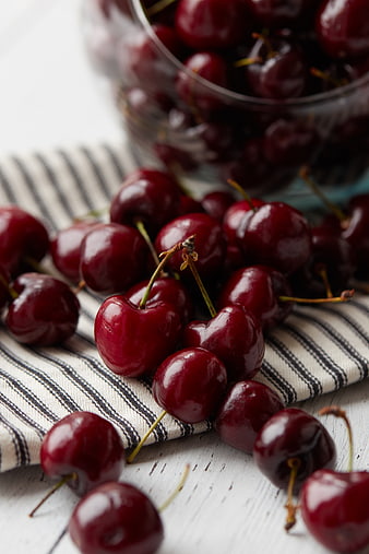 Fresh Red Cherries on Striped Cloth and White Table