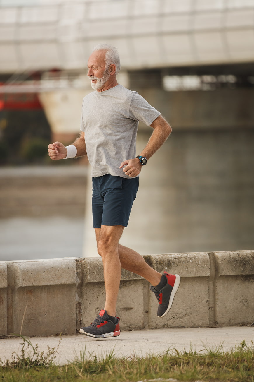 Senior Man Running Outdoors by River