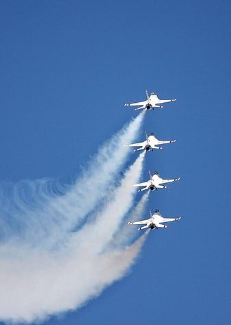 Four Military Fighter Jets Flying In Formation With Smoke Trails