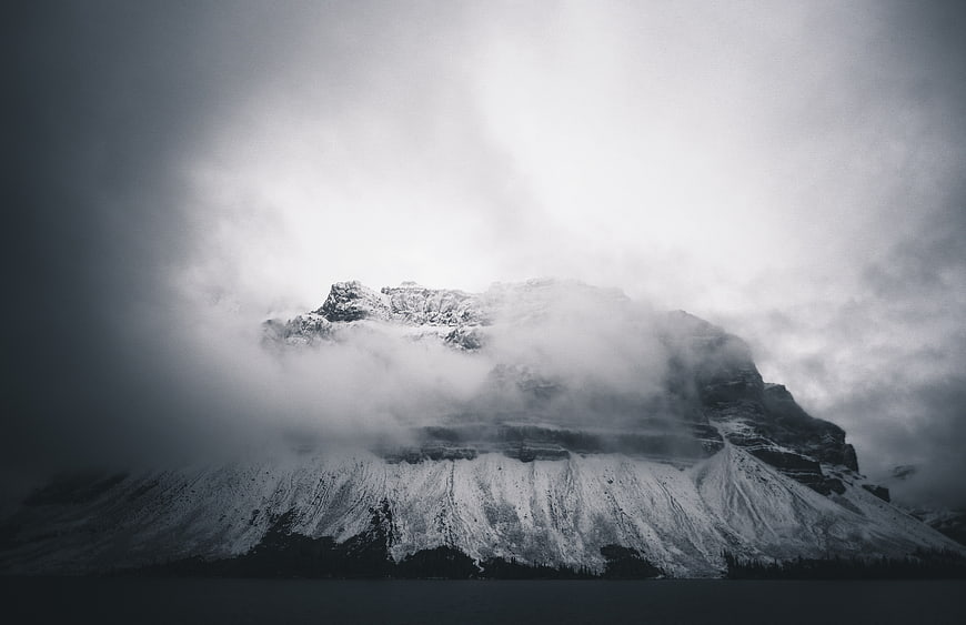 Dramatic Black and White Snowy Mountain Peak in Fog
