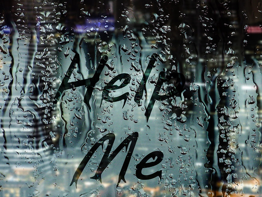 Help Me Written on Rainy Window Glass