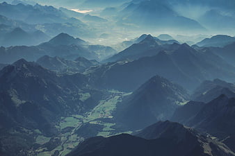 Aerial View of Misty Mountain Ranges and Green Valley