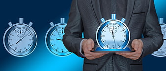 Businessman holding tablet with holographic stopwatch