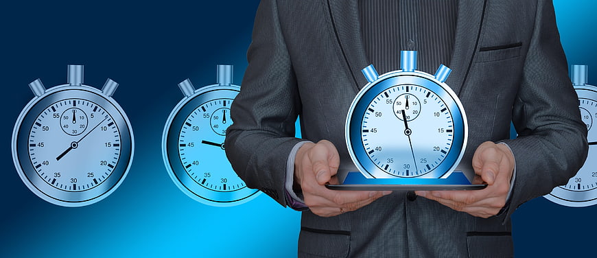 Businessman holding tablet with holographic stopwatch