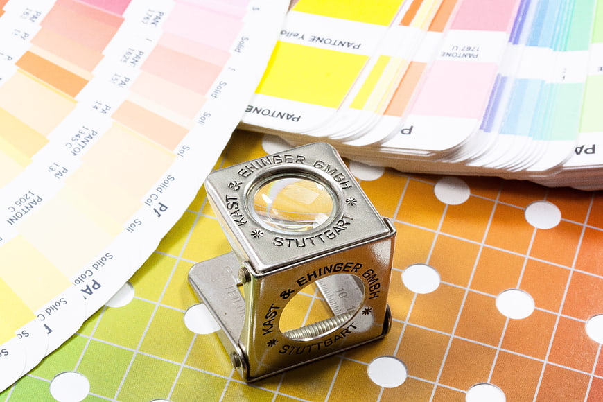 Metallic Thread Counter and Pantone Color Swatches on Grid Surface
