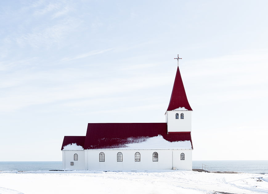 White Church with Red Roof in Snowy Winter Landscape