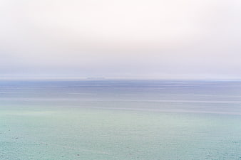 Serene Misty Ocean Horizon with Distant Ship