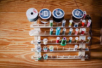 Top View of Sewing Thread Spools on Wooden Rack