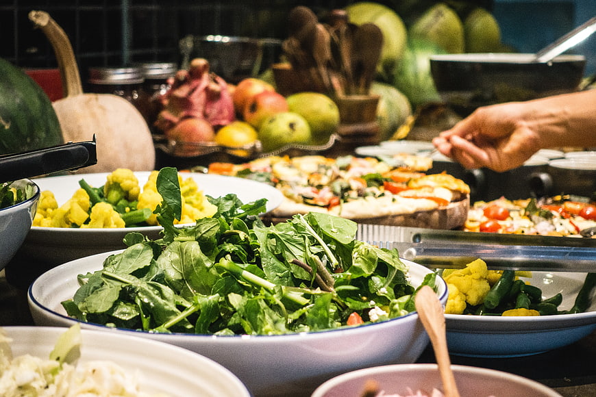 Healthy vegetarian salad buffet with fresh greens and vegetables