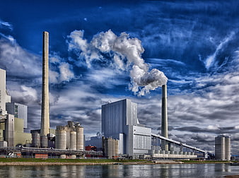 Industrial Power Plant With Smokestacks And Steam Emissions