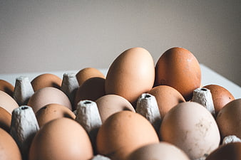 Close-up of brown eggs in a cardboard carton