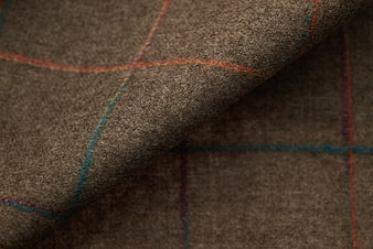 Close-up of brown wool fabric with plaid texture