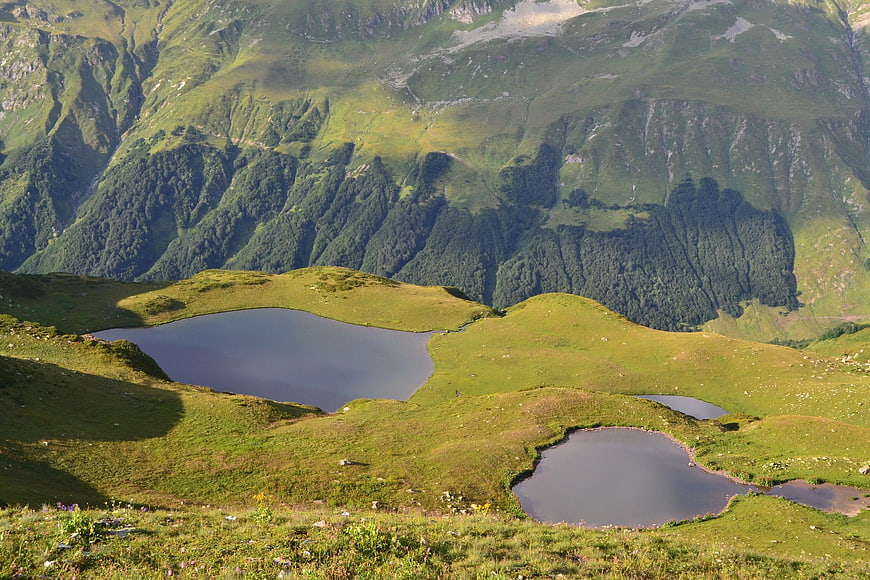Alpine mountain lakes nestled in green meadows
