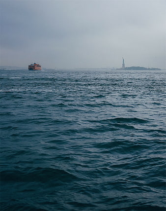 Statue of Liberty and Ferry in Hazy New York Harbor
