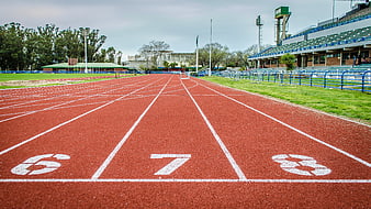 Empty Red Running Track with White Lane Numbers