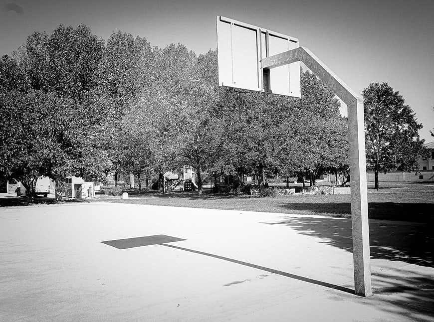 Black and white basketball court with long shadow
