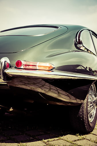 Close-up of vintage green classic car rear bumper and taillight