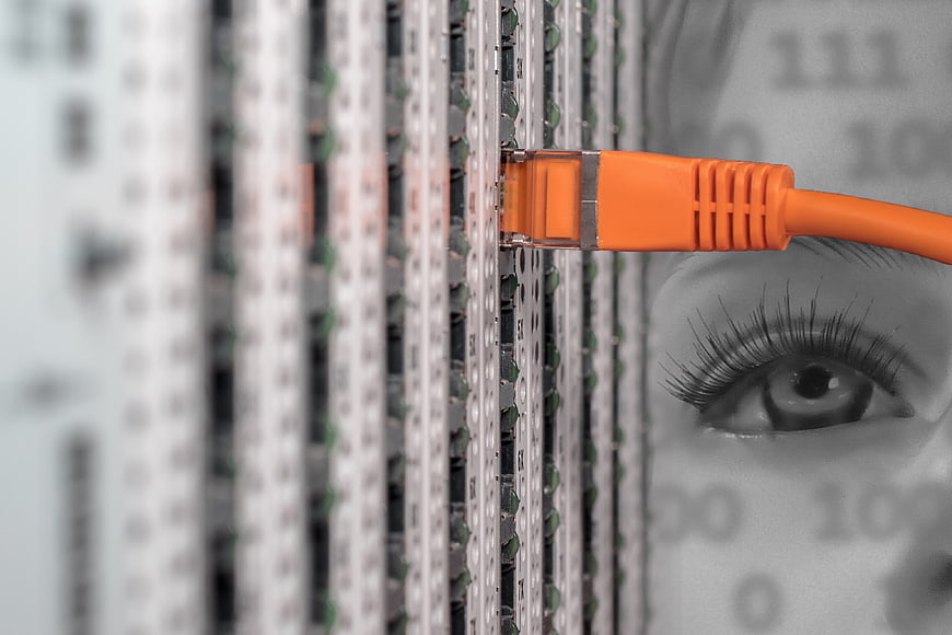 Orange Ethernet Cable Plugged into Server Rack with Woman's Eye