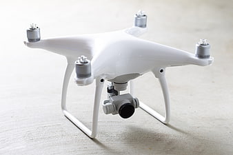 White Quadcopter Drone with Camera on Light Surface