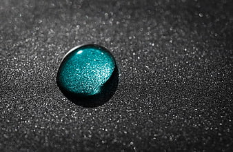 Shimmering Teal Glitter Drop on Dark Textured Background